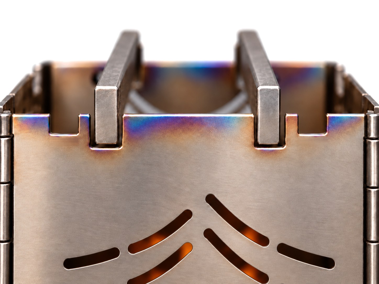 Close-up render of the top of the Stoke stove: two pot bars sitting in the notches along the top edge, with the fire glowing through the mountain cut-outs